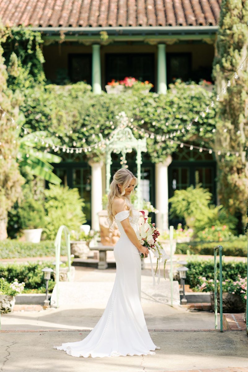Bride in an off-shoulder gown in a garden
