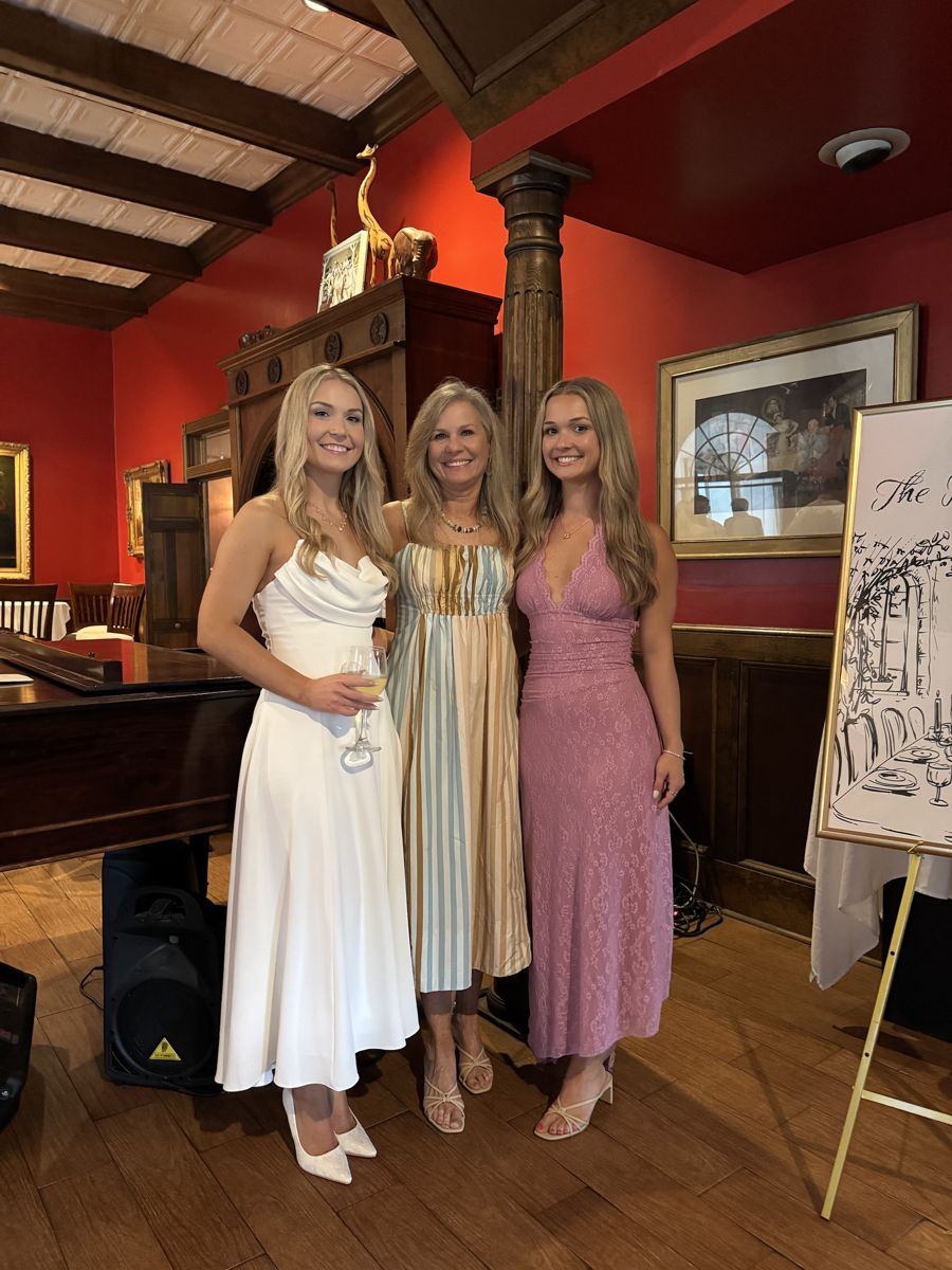 Three women dressed for a wedding